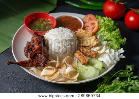 Nasi lemak kukus with quail meat, popular traditional Malaysian local food.