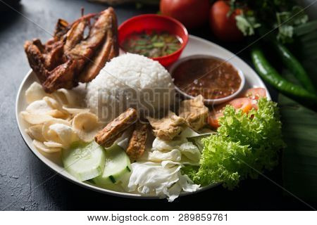 Nasi lemak kukus with fried chicken, popular traditional Malaysian local food.
