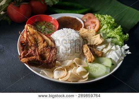 Nasi lemak kukus with fried chicken, popular traditional Malaysian local food.