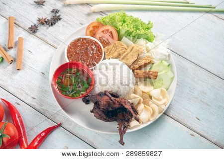 Nasi lemak kukus with quail meat, popular traditional Malaysian local food. Flat lay top down overhead view.
