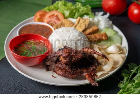 Nasi lemak kukus with quail meat, popular traditional Malaysian local food.