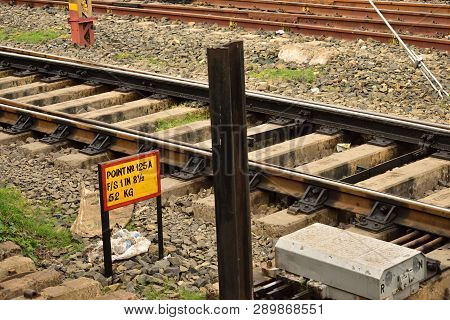 Railway Tracks Lies Beside A Point Signal Of Indian Railway. Beautiful Background Of Rusty Rail Line