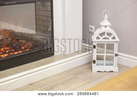 White Decorative Wooden Latern Lights In Expensive Interior Near Fireplace