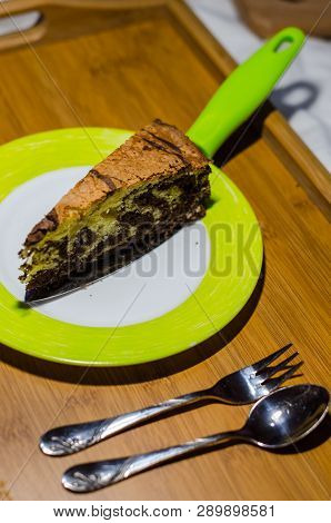 Delicious Homemade Chocolate Cake With Cottage Cheese On The Wooden Table Background. A Piece Is Cut