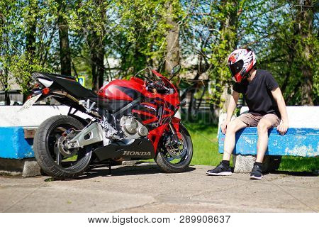 Krasnoyarsk, Russia - May 29, 2018: Beautiful Motorcyclist In Full Gear And Helmet On A Red And Blac