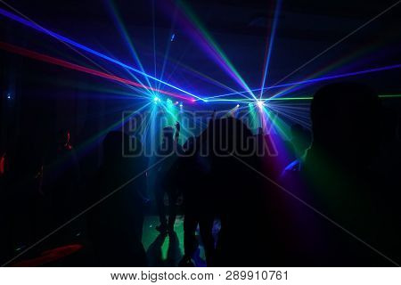 Crowd Of People Dancing Under Disco Laser Light