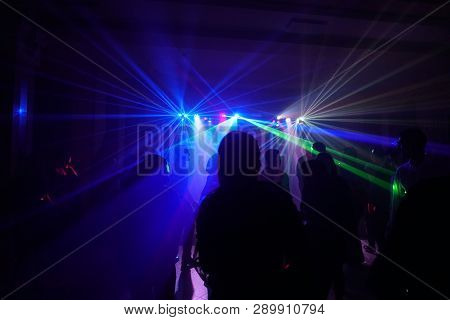 Crowd Of People Dancing Under Disco Laser Light