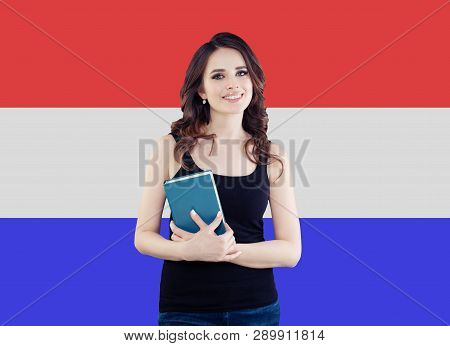 Netherlands Concept With Happy Smiling Woman Against The Netherlands Flag Background. Travel And Lea