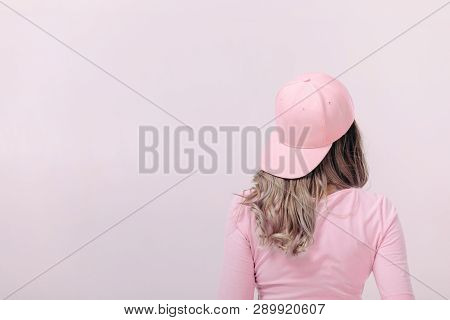Blonde Woman In Pink T-shirt And Pink Cap On Light Background. Femininity And Spring. Copy Space.