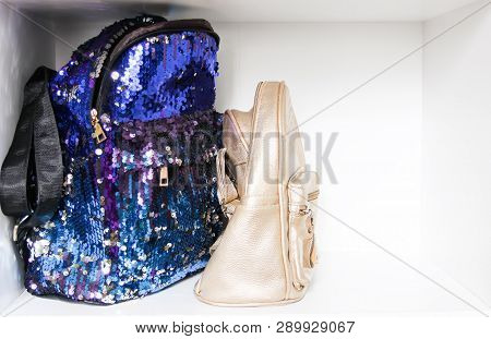 Glitter Satchels On White Shelf In Home Wardrope.