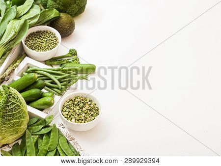 Assorted Green Toned Raw Organic Vegetables On White Background. Avocado, Cabbage, Broccoli, Caulifl