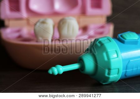 Teeth Model With Dental Tools, Toys On Wooden Background