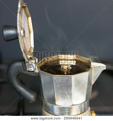 Moka On The Stove.italian Traditional Old Coffee Maker With Hot Espresso  Inside, Open A Coffee Pot,