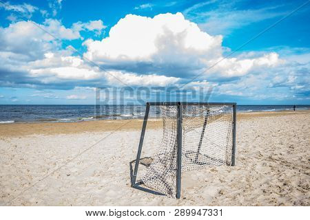 The Football Gate Left On The Empty Beach In A Bright Sunny Day Of The Beginning Of Autumn.
