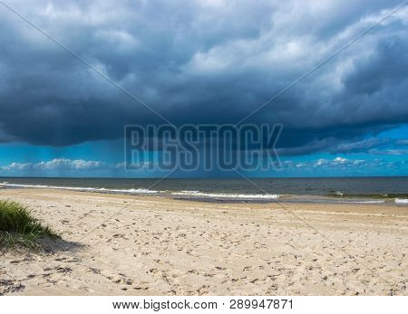 Dark Rain Clouds Above The Baltic Sea. Raining.