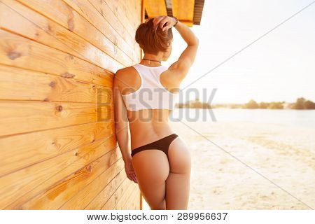 Summer. Beautiful Girl With A Short Haircut On The Beach. Sexy Woman With Perfect Sporty Figure In B