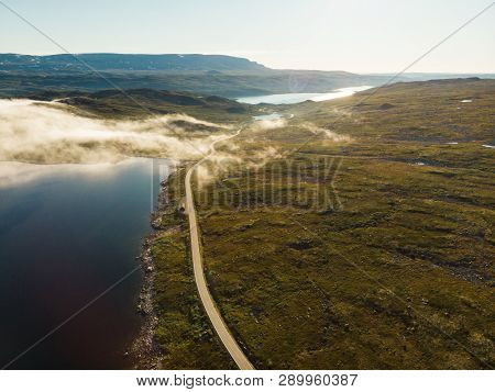 Aerial View. Road Crossing Hardangervidda Mountain Plateau, Clouds Over Lakes, Morning Time. Norway 