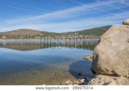 Coast Of The Lake Of Navacerrada And In The Background The City. Spain Madrid Guadarrama.