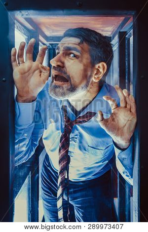 Businessman Inside Of Glass Box. Concept Of Captivity, No Freedom. Stressful Job, Pressure At Work. 