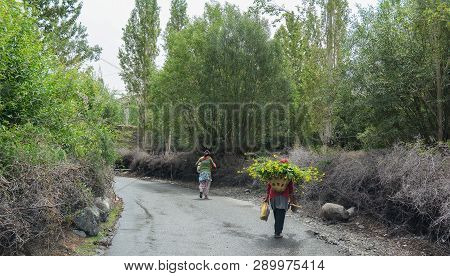 Tibetan People Walking On Rural Road