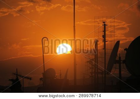 The Red Hot Sun Sets Over The Horizon