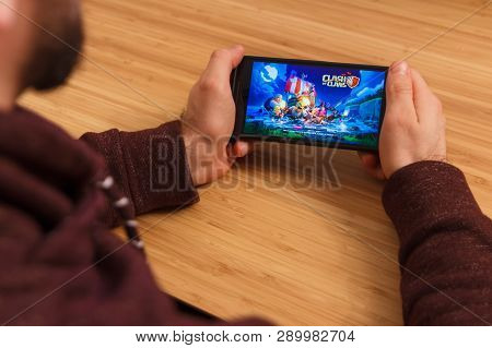 Prague, Czech Republic - March 16, 2019: Man Holding A Smartphone And Playng The Clash Of Clans Mobi