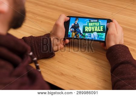 Prague, Czech Republic - March 16, 2019: Man Holding A Smartphone And Playng The Fortnite: Battle Ro