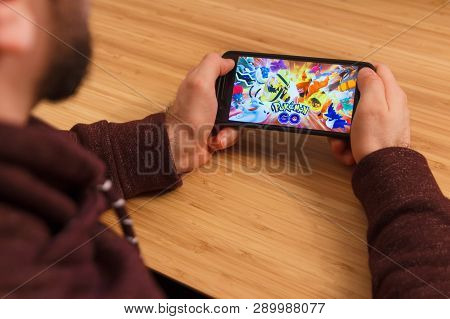 Prague, Czech Republic - March 16, 2019: Man Holding A Smartphone And Playng The Pokemon Go Mobile G