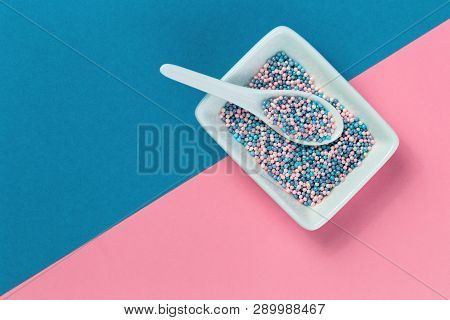 Colorful Nonpareils Cake Candy Sprinkles In White Rectangular Bowl And Spoon On Pink Blue Background