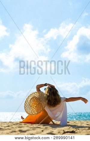 Woman enjoying her holidays on a transat at the tropical beach in Thailand