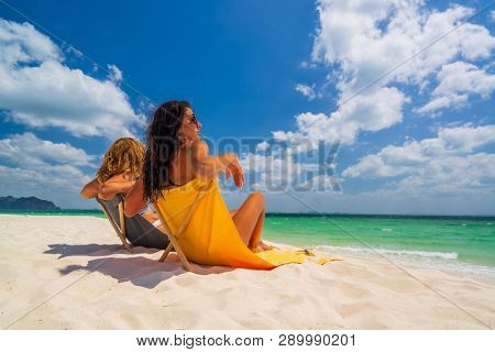 Two Women enjoying their holidays on a transat at the tropical beach in Thailand