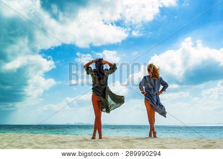 Two Women enjoying their holidays on a transat at the tropical beach in Thailand.