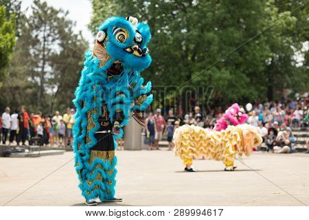 Columbus, Ohio, USA - May 27, 2018  Members of the Tay Phuong Monastery perform a lion dance at the Asian Festival.