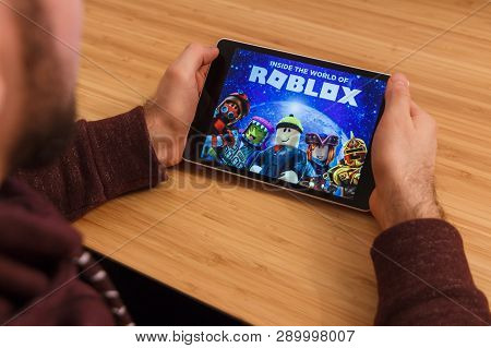 Prague, Czech Republic - March 16, 2019: Man Holding A Smartphone And Playng The Roblox Mobile Game.