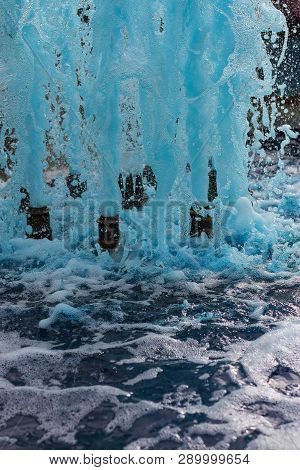 Foreground In Vertical View Of A Source Expelling Blue Water