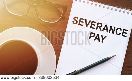 Text, The Inscription, The Phrase Severance Pay Is Written In A Notebook That Lies On A Dark Table W