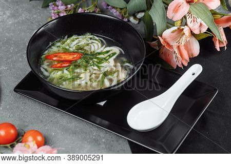 Bowl Of Chicken Noodle On Gray Concrete Background