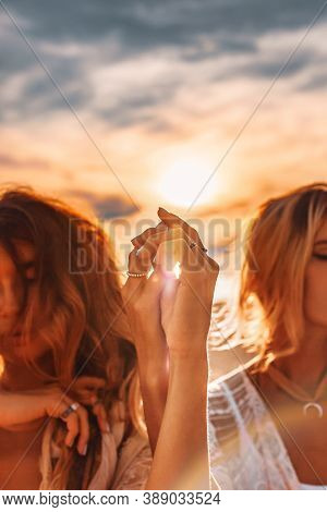 Two Beautiful Young Woman In Elegant Boho Dresses Oudoors At Sunset