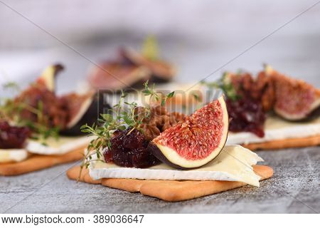 Cracker With A Slice Of Camembert, Jam, Figs And Nuts.
A Great Snack Idea For A Holiday, Picnic Or P