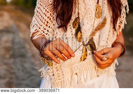 Beautiful Boho Woman In A Sunny Field At Sunsrt.