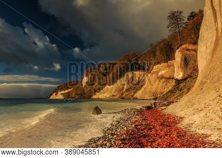 Chalk Cliffs In The Morning On The Island Of Ruegen. Coastline In Autumn At Sunrise With Sunshine. T