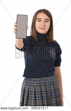 Pre-adolescent Girl Holding Black Smartphone With Blank Screen. Isolated On White Background. High R