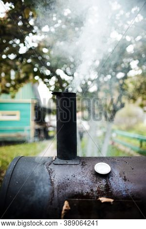 Outdoor Barbecue Grill. The Smoke From Cooking Rises Into The Sky