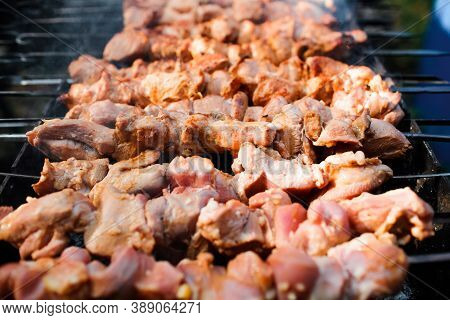 The Meat Is Grilled On Charcoal, Close-up. Cooking Barbecue Outdoors