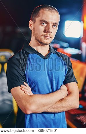 Vertical Shot Of Young Confident Caucasian Guy, Male Cyber Sport Gamer Keeping Arms Crossed And Look