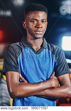 Vertical Shot Of Young Confident African Guy, Male Cyber Sport Gamer Keeping Arms Crossed And Lookin