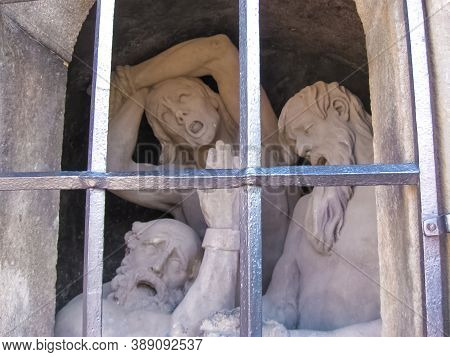 Prague, Czech Republic - 26 June, 2010: Sculpture Of The Dog Guarding A Man Locked In The Cage Of Th