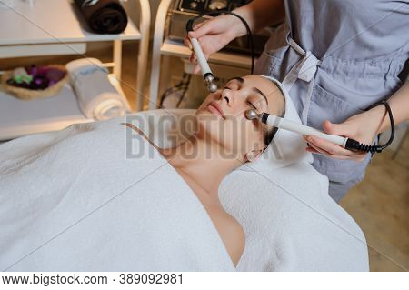 Lateral View Of Woman Facial Massage Spa Procedure. Electric Stimulation Facial Skin Care. Microcurr