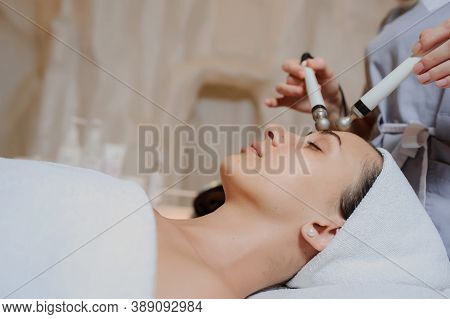 Lateral View Of Woman Facial Massage Spa Procedure. Electric Stimulation Facial Skin Care. Microcurr