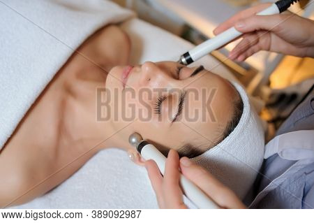 Lateral View Of Woman Facial Massage Spa Procedure. Electric Stimulation Facial Skin Care. Microcurr